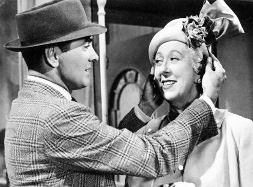 Tyrone Power admires Norma Varden's hat in…